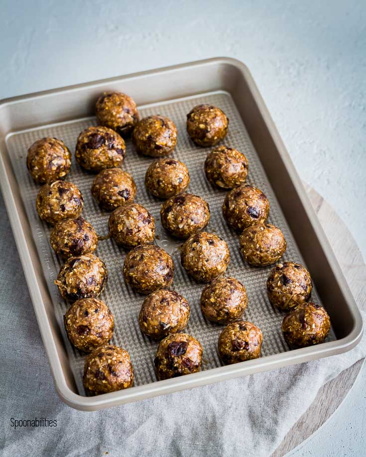 Twenty five Protein Energy Bites in a baking tray. Spoonabilities.com