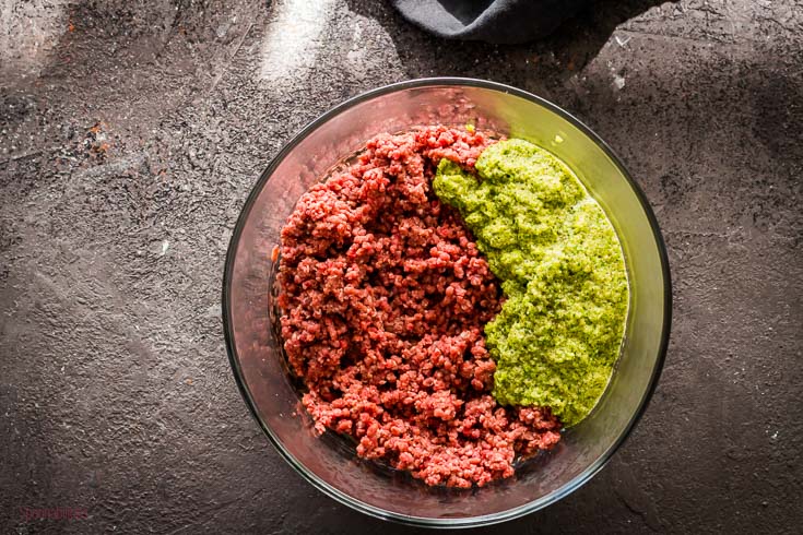 Ground beef with the Dominican seasoning in a round glass bowl. Spoonabilities.com