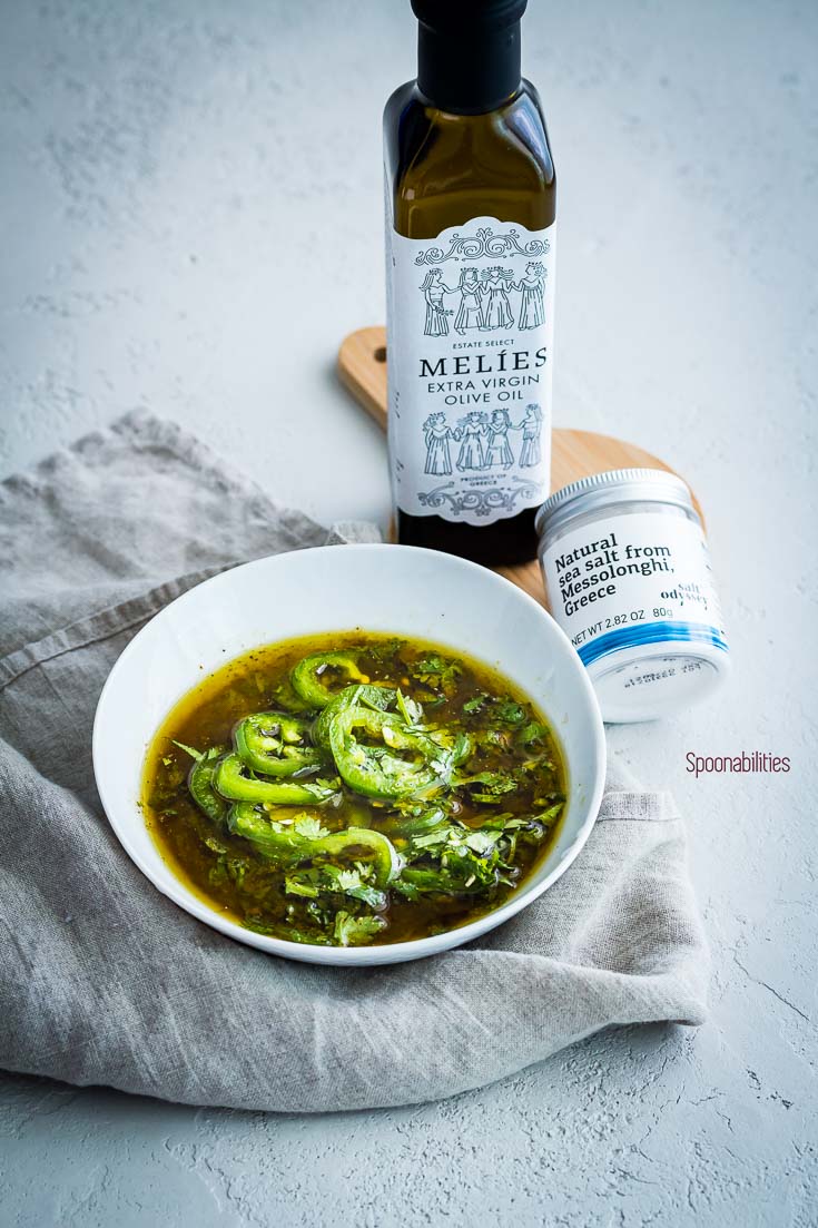 Jalapeño Lime marinade in a small bowl next to a bottle of Melies extra virgin olive oil and Greek sea salt. Spoonabilities.com