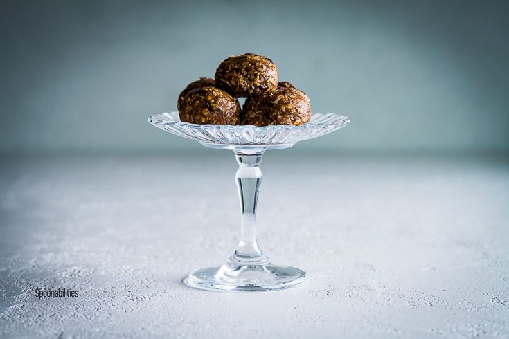 Five Protein Energy Bites in a glass pedestal. No bake recipe. Spoonabilities.com