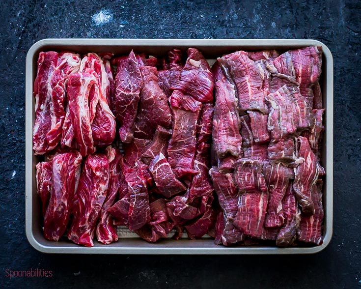 Beef cut into stripes in a small baking tray. Spoonabilities.com