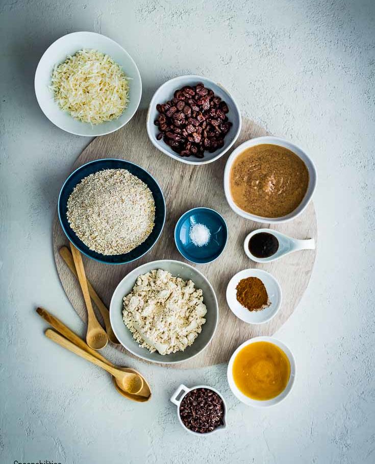 Overhead photo with the ingredients in small bowls for the Protein Energy Bites. Spoonabilities.com