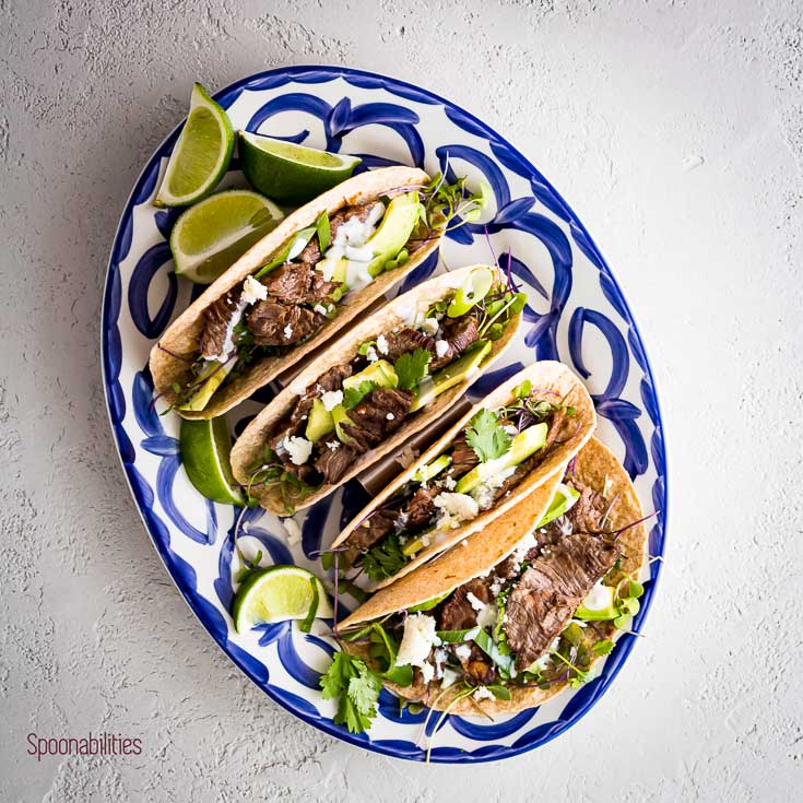 Juicy and tender grilled Skirt Steak Tacos topped with avocado, cilantro, queso fresco, and sour cream. Spoonabilities.com
