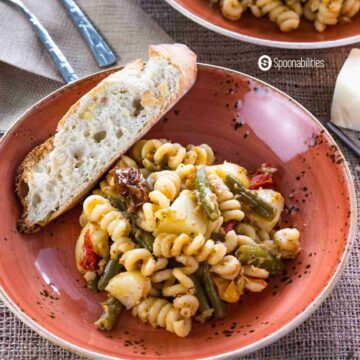 Artichoke Pesto Pasta Salad with with a piece of bread