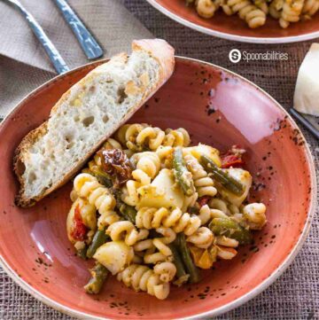 Artichoke Pesto Pasta Salad with with a piece of bread