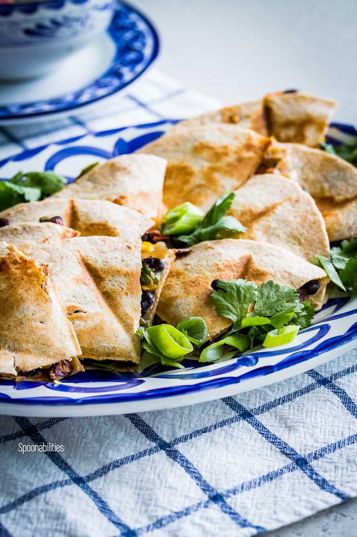 Very close photo showing the details of the vegetarian quesadillas garnished with cilantro and scallions. Spoonabilities.com