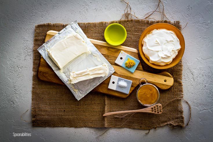 Cream cheese, Labneh cheese, lemon juice, lemon zest, sea salt & honey on a wooden board.