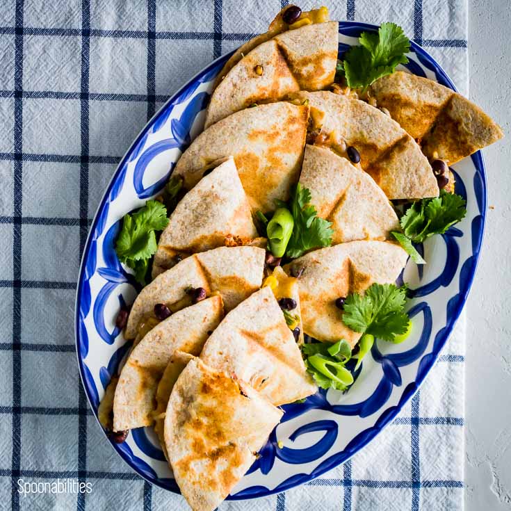 Overhead photo with a delicious veggie quesadillas in a Mexican style oval plate. Spoonabilities.com