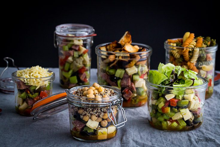Six variation salad in Jar filled with Antipasto, pasta, quinoa, lettuce, orzo & cubed bread. Spoonabilities.com