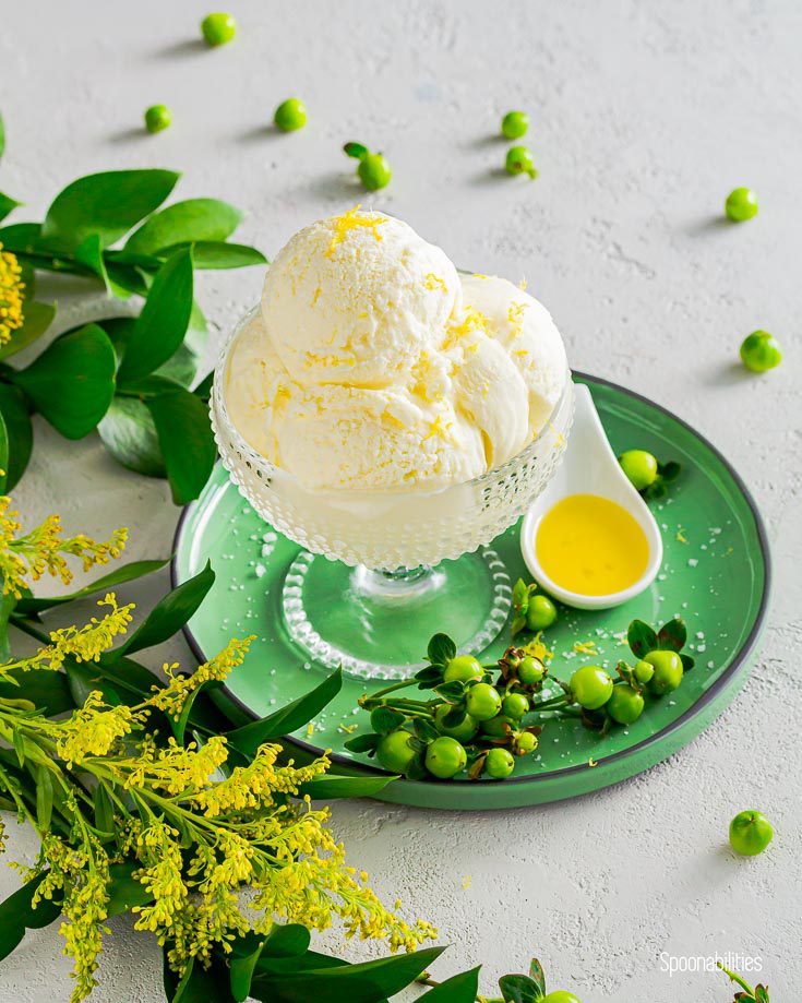 Glass dessert bowl on a green round plate with three ice cream scoop with extra virgin olive oil. Spoonabilities.com