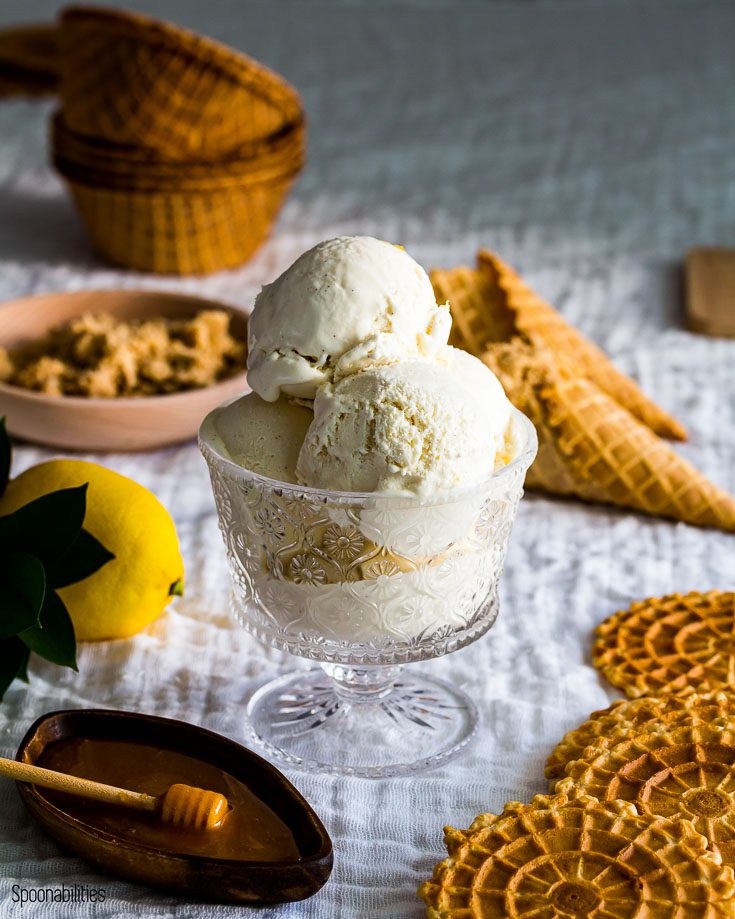 Three scoop of homemade labneh ice cream with waffle cones in the background.