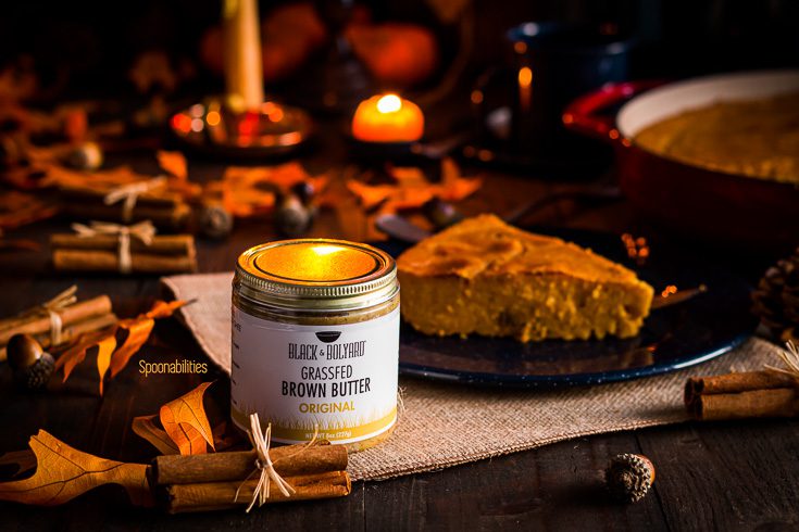 A Jar of Black & Bolyard original brown butter and in the background a fall decor with leaves, candles, pumpkins and a plate with a Dominican Republic dessert. Available at Spoonabilities.com