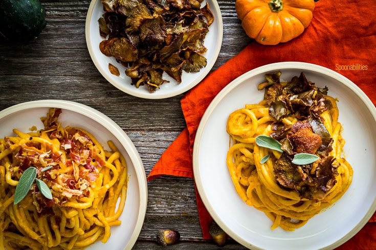 overhead photo with two bowl with pasta and Pumpkin Pasta Sauce, and one small plate with crispy oyster mushrooms. Spoonabilities.com