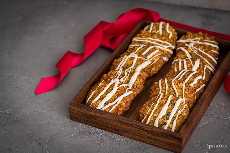 Oatmeal cookies presented in a small wooden tray with a red ribbon in the right side of the box. Spoonabilities.com