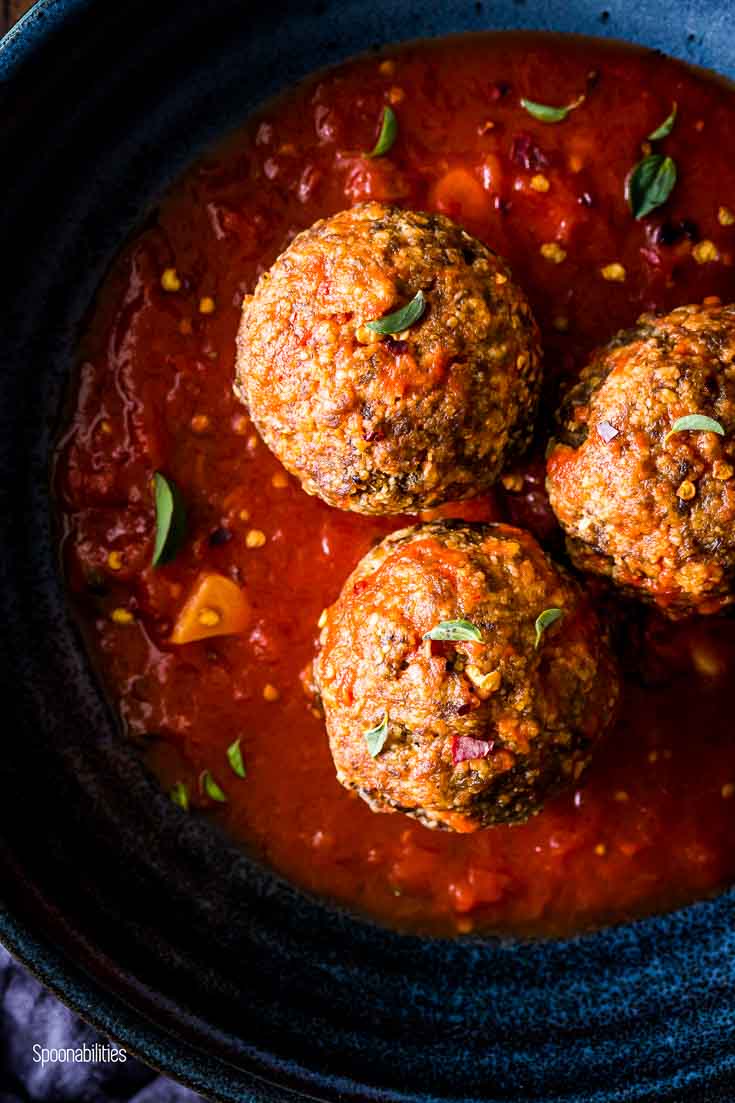 Close up of the brisket meatballs in the blue bowl. Spoonabilities.com