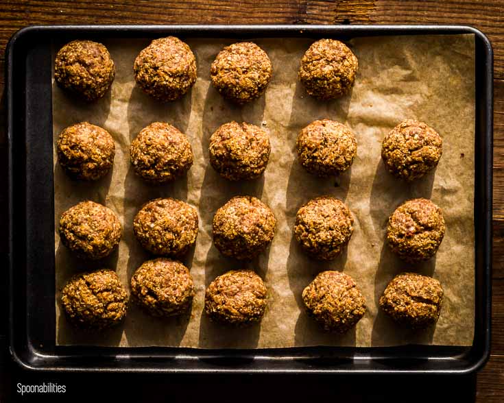 16 cooked meatballs in the baking tray. Spoonabilities.com