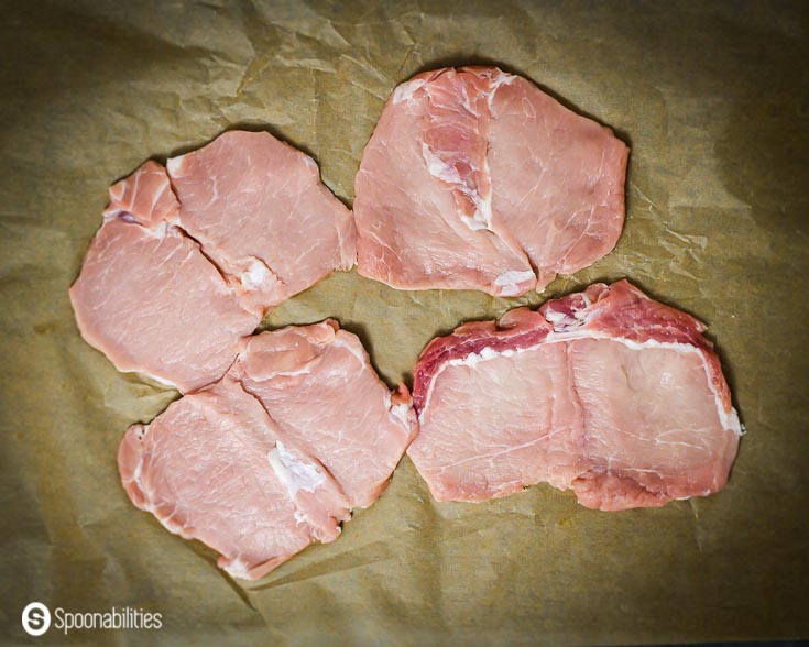 Four pieces of Butterfly pork chops. Recipe at Spoonabilities.com