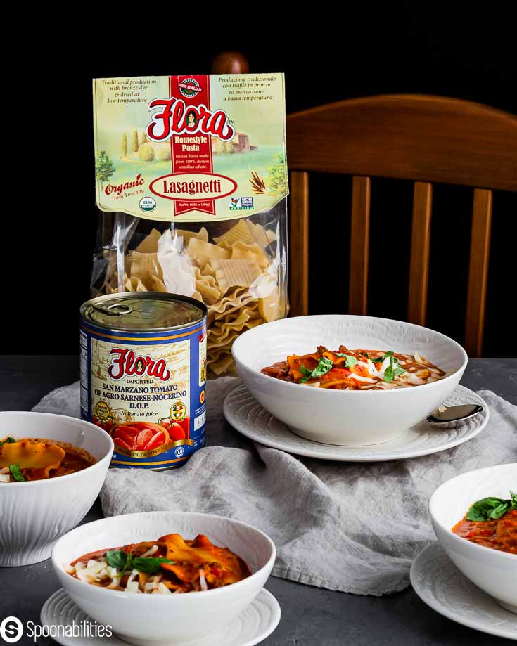 Flora products: San Marzano tomatoes and lasagnetti homestyle pasta . The products are next to four white bowl with the lasagna soup. recipe at Spoonabilities.com