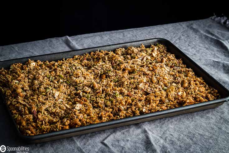 Baking tray with the granola mixture after came out of the oven. Recipe at Spoonabilities.com