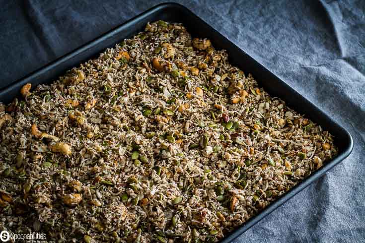 Baking tray with the granola mixture before go to the oven. Recipe at Spoonabilities.com