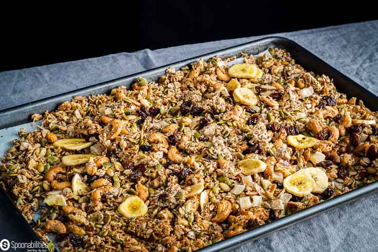 Baking tray with the baked granola with the dried fruits. recipe at Spoonabilities.com