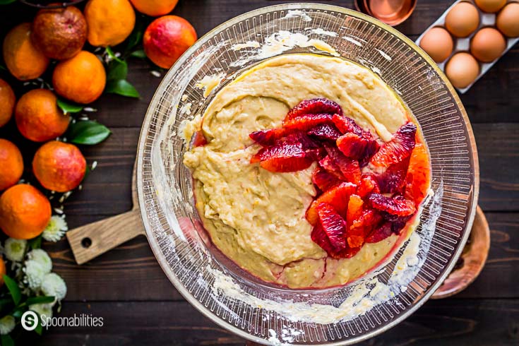 In this step, I'm adding the blood orange segments to the batter of the olive oil cake. Recipe details at Spoonabilities.com