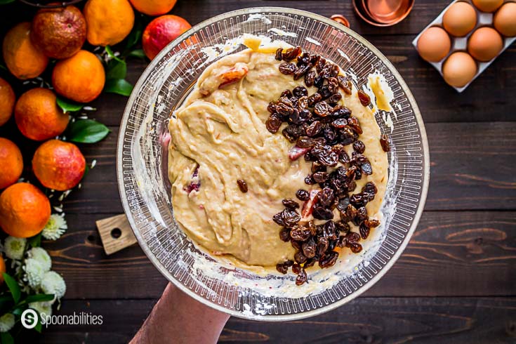 In this step, I'm adding the raisins to the batter of the blood orange olive oil cake. Recipe details at Spoonabilities.com