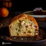 A loaf with a piece out showing the inside of the blood orange olive oil cake. Recipe at spoonabilities.com