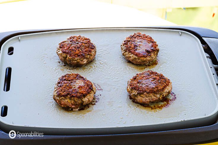 Grilling the second side of the spiced lamb patties. See the rest of the recipe at Spoonabilities.com