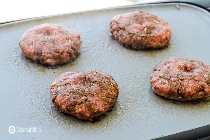 Grilling the first side of the spiced lamb patties. See the rest of the recipe at Spoonabilities.com