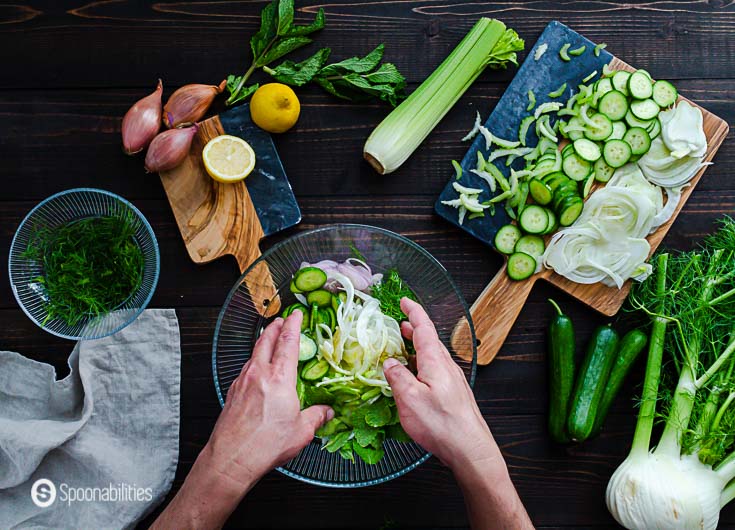 Mixing the fennel, cucumber & celery slaw in a glass bowl. Details of this recipe at Spoonabilities.com