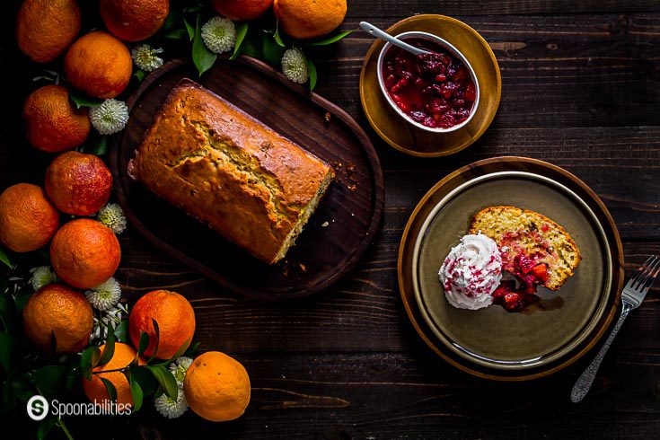 Overhead photo with a loaf of blood orange cake with a small bowl with the compote. More details at Spoonabilities.com