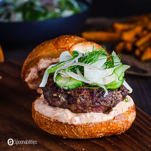 Close up of the Spiced Lamb Burger topped with a Celery, Cucumber & Fennel Slaw. Recipe details at Spoonabilities.com