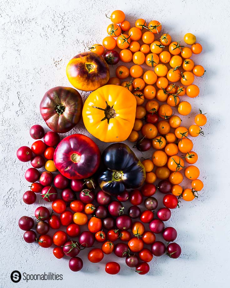 A mix of cherry tomatoes and heirloom tomatoes in different colors. Spoonabilities.com