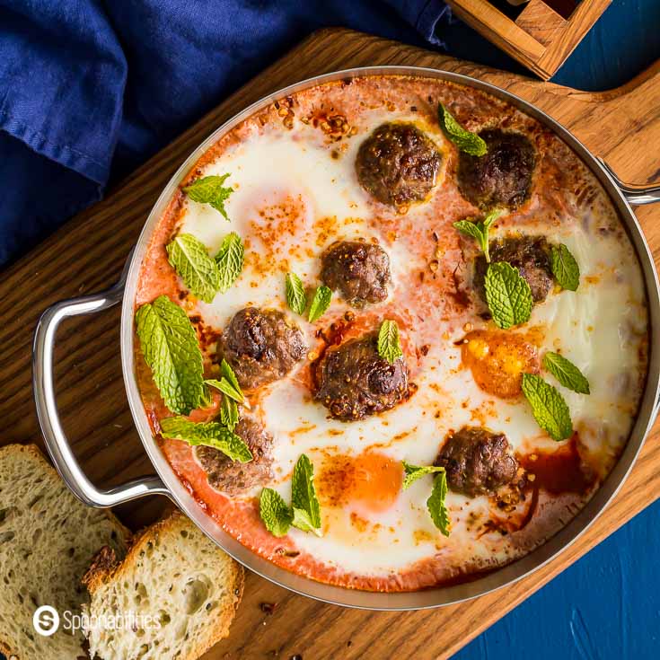 Close Up of the Easy shakshuka with Lamb Meatballs & Fig Salami in a saucepan. Recipe at Spoonabilities.com
