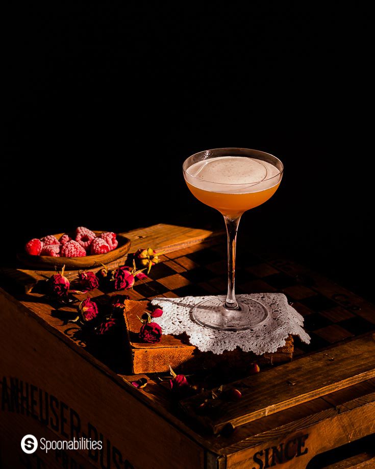 French martini on a white doily with frosted fresh raspberries