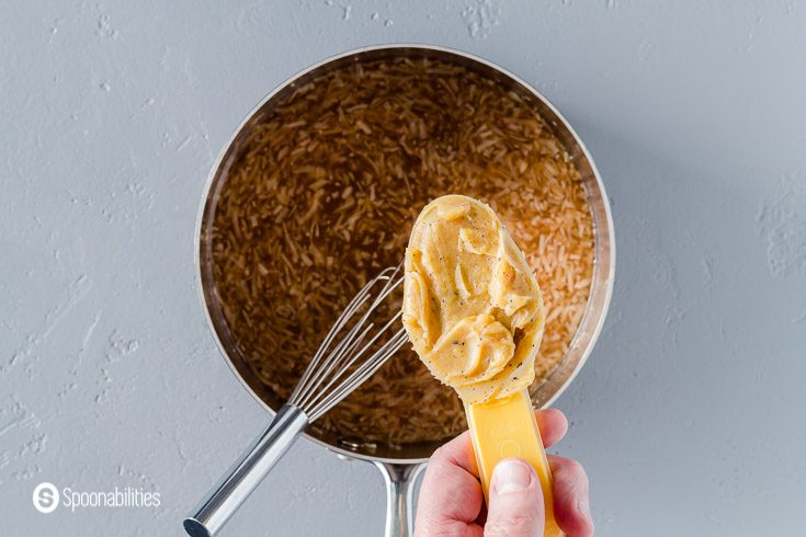 Adding the sage honey brown butter to the ice cream base. Recipe at Spoonabilities.com