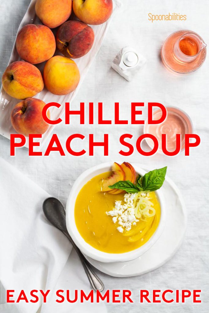 white bowl of Chilled peach soup next to bowl of whole peaches