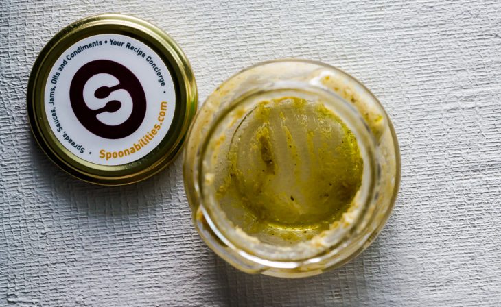 Overhead shot of empty mustard jar with the Spoonabilities logo on the lid on the side.