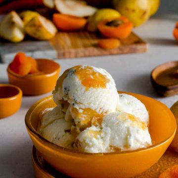 Four scoop of the Pear Blue Cheese Ice Cream in an orange bowl. Recipe at spoonabilities.com