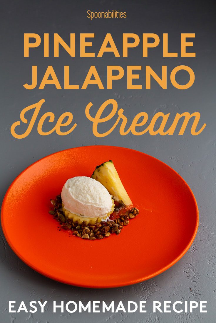 Dark orange plate with oval scoop of jalapeno pineapple ice cream, and fresh pineapple slice