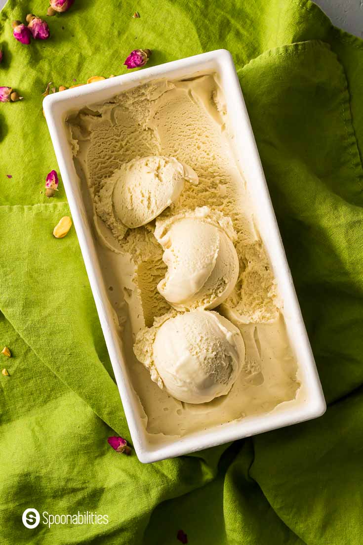 White container with three scoop of Persian ice cream. Recipe at Spoonabilities.com
