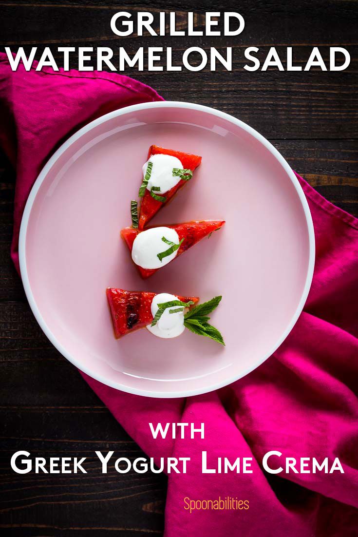 Overhead photo with a pink round plate with three pieces of grilled watermelon salad with Greek Yogurt Lime Crema. Recipe at Spoonabilities.com