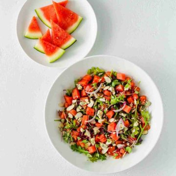 Recipe card photo with a overhead photo of a white round serving plate with a watermelon salad. Recipe at Spoonabilities.com