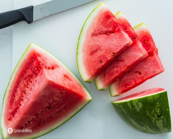 2 large sections of watermelon with 3 cut slices