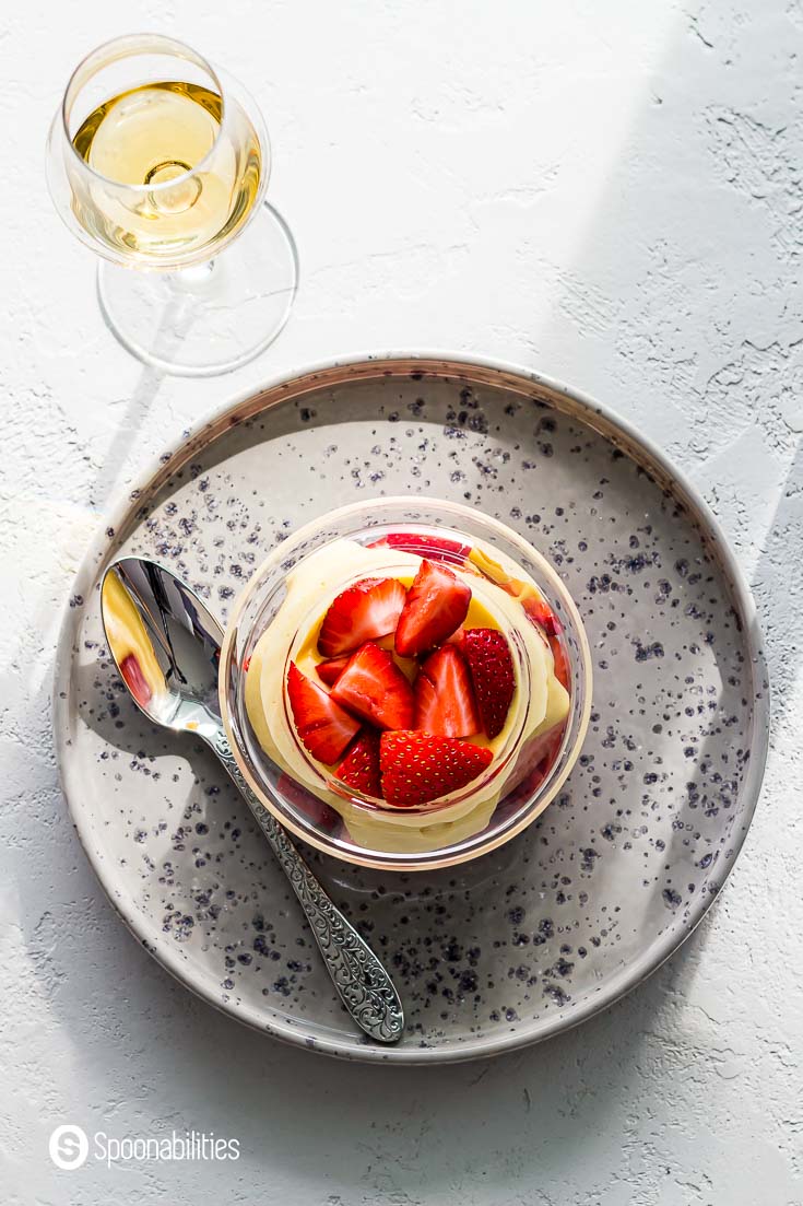 Overhead photo of this Italian dessert with fresh strawberries. This custard dessert is in a glass bowl. More about this recipe at Spoonabilities.com