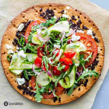 Close up photo for the vegetable pizza recipe. Topped with fresh veggies and cauliflower pizza crust. Recipe at Spoonabilities.com