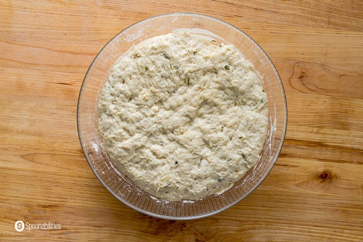 The naan bread dough after the Rest time and double the size in glass bowl and formed into a dough. Recipe at Spoonabilities.com