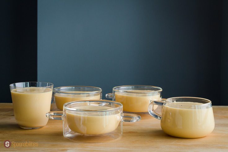 Five glass dishes with Pumpkin coconut panna cotta ready to go into the fridge to set for a least 8 hours. Recipe at Spoonabilities.com