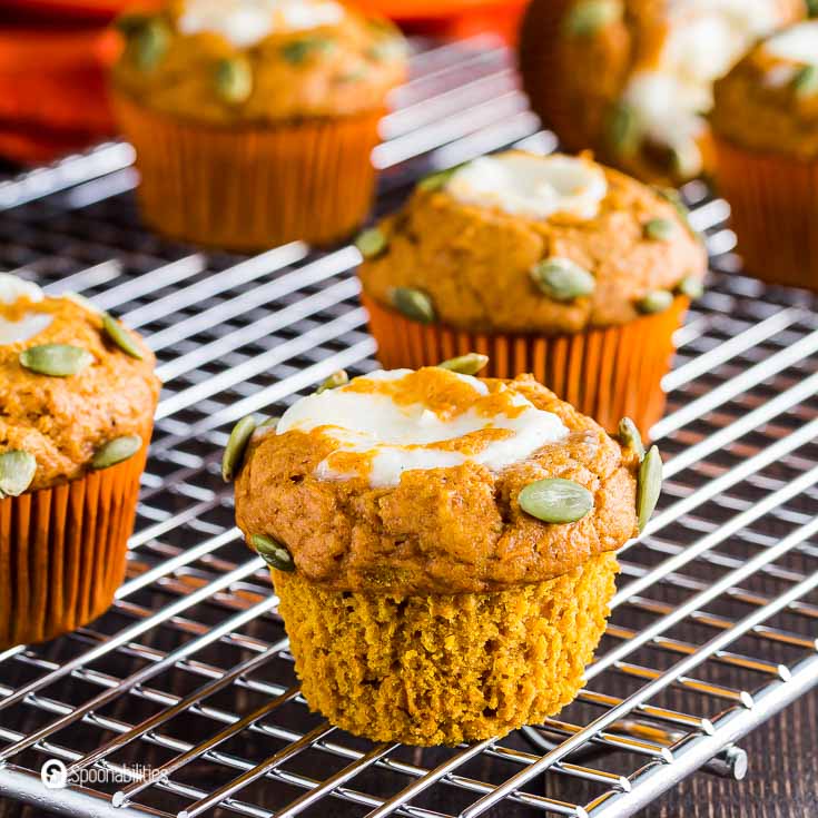 Close up of a muffins made with pumpkin puree and cream cheese filling. Recipe at Spoonabilities.com